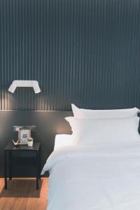 a bedroom with a bed and a nightstand with a bed sidx sidx at 41Cafetel in Bangkok