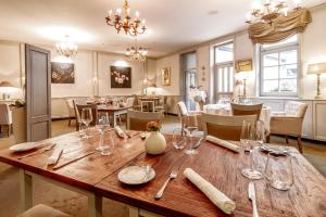a dining room with a table with wine glasses at Boutique Hotel U Solné brány in České Budějovice