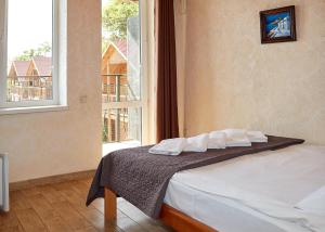 Postel nebo postele na pokoji v ubytování Tikhaya Gavan Hotel