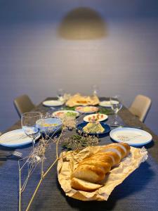 a table with plates of food and wine glasses at Randor Hotel Sapporo Suites in Sapporo