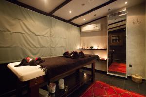 a room with a bed and a bathroom with a shower at Medina Loft & Spa in Marrakesh