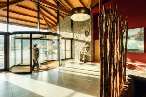 a lobby with a person walking in a building at Hotel Spa Aguas de los Mallos in Murillo de Gállego