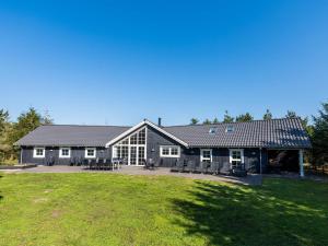 a large house with a large lawn in front of it at 14 person holiday home in Blåvand in Blåvand