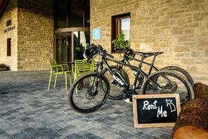 a bike parked in front of a building with a sign at Hotel Spa Aguas de los Mallos in Murillo de Gállego