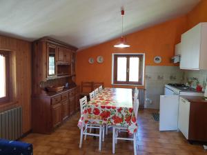 a kitchen with a table and chairs in a room at Appartamenti Bice Abetone in Abetone