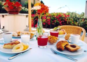 
a table topped with plates of food and drinks at Hotel Angedras in Alghero

