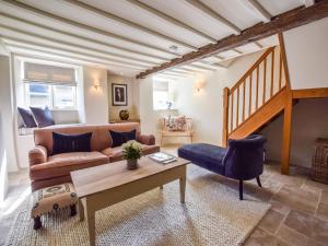 a living room with a couch and a table at Lovell Cottage in Witney +17 photos