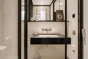 a bathroom with a sink and a mirror at Seventy Barcelona in Barcelona