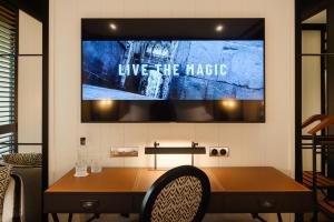 a tv hanging on a wall with a table at Seventy Barcelona in Barcelona
