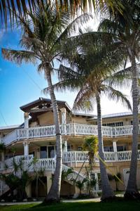 a large building with palm trees in front of it at Coconut Cove Resort & Marina in Islamorada