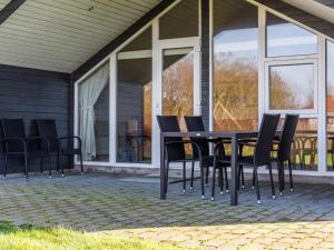a black table and chairs on a patio at Tranquil Cottage with Spa and Sauna-By Traum in Hemmet