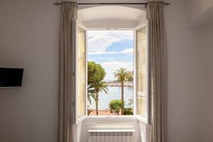 a window with a view of the water at Butterfly Apartment in Rapallo