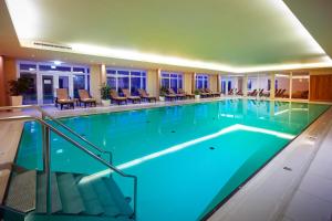 a large swimming pool in a hotel room at Hotel Rimberg in Schmallenberg