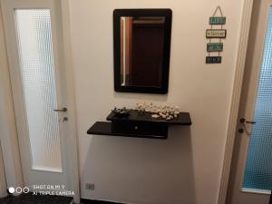 a bathroom with a sink and a mirror on the wall at Casa di Teo in Rapallo +17 photos