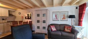 a living room with a couch and a kitchen at De Spaier 3a in Zoutelande
