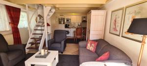 a small living room with a couch and a table at De Spaier 3a in Zoutelande