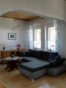 a living room with a couch and a table at Ferienwohnung Gladbeck-Rohde in Gladbeck