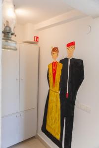 a painting of a man and a woman on a wall at Apartments villa Mira in Kaštela