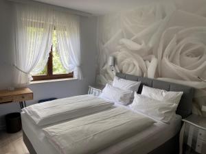 a bedroom with a large bed with a wall with roses at Hotel-Restaurant Sebastianushof in Bonn