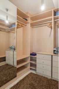 a walk in closet with white cabinets and a rug at Apartments in Old Town in Marbella