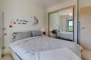 a bedroom with a large bed and a mirror at One Bedroom Apartment in Albur Village 2J in Alvor