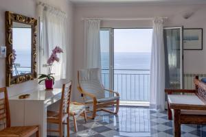 a living room with a view of the ocean at Polanesi Sea view Home in Sori