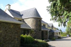 a brick house with a chimney on top of it at AbbeyCourt Kenmare Kerry in Kenmare +19 photos