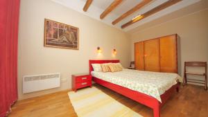 a bedroom with a bed and a painting on the wall at Karja Holiday Apartment in Pärnu