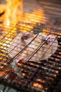 a chicken and turkey are cooking in a grill at Phi Phi The Beach Resort- SHA Certified in Phi Phi Islands