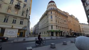 a person riding a bike on a city street at Pension Lerner in Vienna