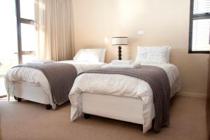 a bedroom with two beds and a window at Cathkin Haven in Champagne Valley +23 photos