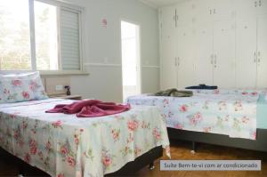 Un ou plusieurs lits dans un hébergement de l'établissement Pousada Happy Inn
