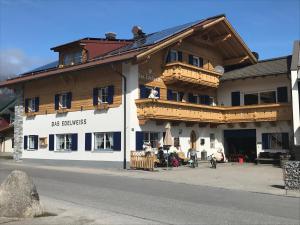 a large wooden building on the side of a street at Das Edelweiss in Grän