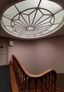 a circular ceiling with a wooden staircase in a building at Abri du Passant in Roubaix
