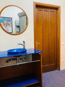 a bathroom with a blue sink and a mirror at Status Hotel in Poltava