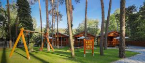 a playground in front of a log cabin at Relaks 2 Boszkowo in Boszkowo