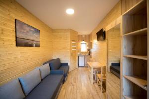 a living room with a couch and a table at Relaks 2 Boszkowo in Boszkowo +24 photos
