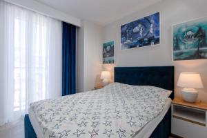 Posteľ alebo postele v izbe v ubytovaní Resort Apartamenty Klifowa Rewal 32