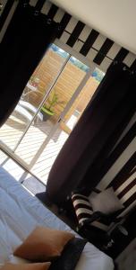 a bedroom with a bed and a large window at Le cosy de sarah in Bordeaux-Saint-Clair