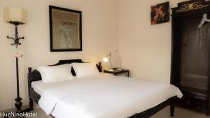 Postel nebo postele na pokoji v ubytování Hue Nino Hotel