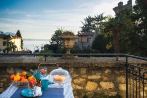 a table with fruit on it on a balcony at La Maison Du Lac Iseo in Predore