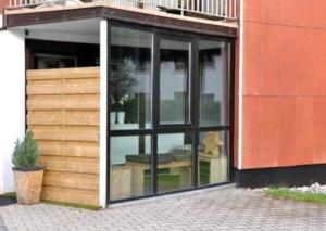a glass building with a table inside of it at Appartement Altreichenau in Neureichenau