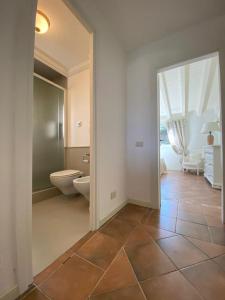 an empty bathroom with a toilet and a sink at Appartamento Gli Oleandri 138 - Costa Smeralda-Porto Cervo in Liscia di Vacca