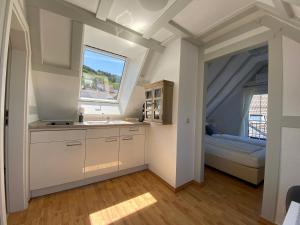 a kitchen with a sink and a window and a bed at Haus von Hoegen in Cochem