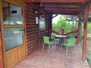 a wooden deck with a table and chairs on it at U Marzeny in Malbork