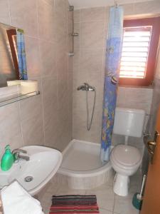 a bathroom with a sink and a toilet and a shower at Vala in Božava