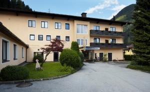 a large building in the middle of a street at Residence AlpenHeart in Bad Gastein
