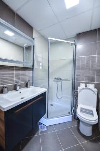 a bathroom with a shower and a toilet and a sink at Vanilla Boutique Hotel in Skopje +95 photos