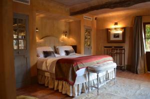 a bedroom with a large bed in a room at Les Rosées in Mougins