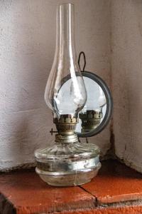 a glass lamp sitting on a table with a mirror at Casa Baroca in Sighişoara